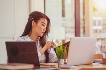 Female employee working on project in office.