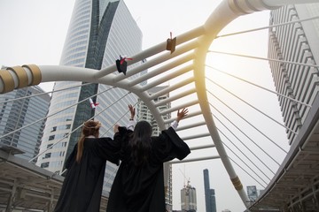 Graduated student throw hat in the air to celebrate graduation