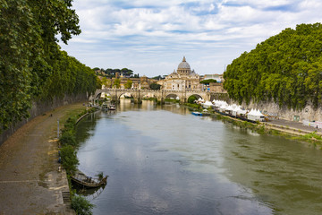 Fototapeta na wymiar View of Tiber river with Saint Peter's Dome at distance in Rome, Italy