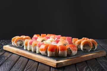 Big set of rolls served on stone plate. Layout for menu.