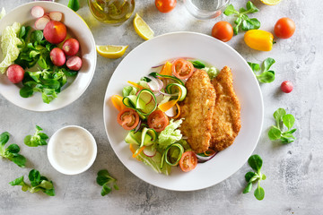 Vegetable salad and breaded chicken breast