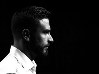 Monochrome portrait of a strong man with a beard. He looks at the camera with different emotions.  - 206561464