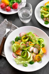 Vegetable salad from zucchini, radish, greens