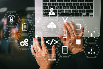 cyber security internet and networking concept.Businessman hand working mobile phone on laptop computer background