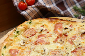 Pizza thin with sausage, mushrooms, cheese, spices, a glass of juice, tomatoes, nuts