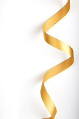 Gold ribbon on a white background.