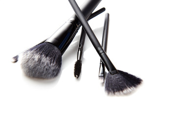 Selection of makeup brushes isolated on white.