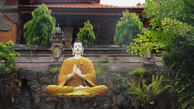 Statue of the Buddhist God Buddha in the Buddhist temple Brahma Vihara Arama with statues of the gods on Bali island, Indonesia. Bali Architecture, Ancient design. Travel concept.