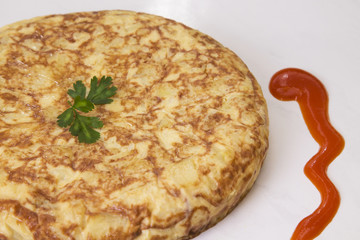 Spanish omelette with potatoes and onions with tomato sauce