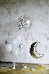 Decorations for holiday party. Beautiful balloons grey and white colors. paper balls. 