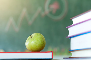 Textbooks and apple on a desk,education concept.