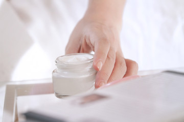 Obraz na płótnie Canvas pick up a jar of moisturizer cream