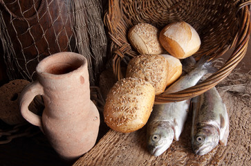 Wine jug with bread and fish