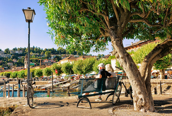 Couple sitting on bench in Ascona  Ticino summer Switzerland