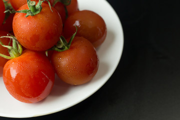 close up fresh tomato on black table  background.