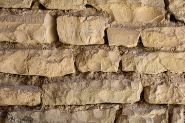 Fototapeta premium Texture of an ancient brick wall made of sandstone. Archaeological excavations. Abstract background for design