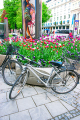 Fototapeta na wymiar Bicycles and street flowerbed at old center of Munich