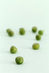 Fresh peas on green background.