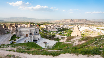 Fototapeta premium modern and ancient rock-cut buildings in Uchisar