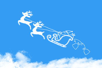 Clouds shaped Santa Claus driving in a sledge on blue sky