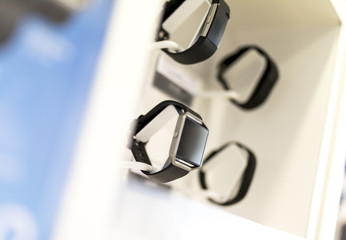 Smart watches and gadgets on display in a retail environment in a shop or mall