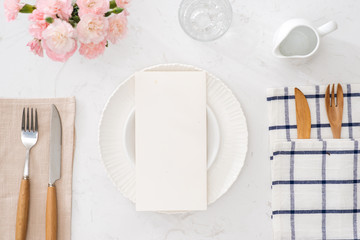 white plate without food with a fork and knife