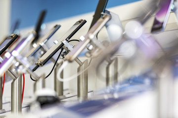 Close up of cell phones or mobile phones on display in a modern, clean and contemporary shop or mall