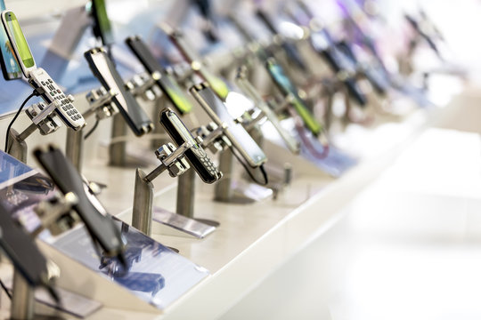 Close up of cell phones or mobile phones on display in a modern, clean and contemporary shop or mall