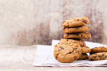 Chocolate oatmeal cookies on the wooden background.