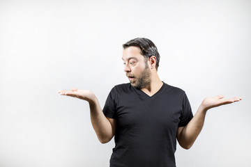 Fototapeta premium Adult man is comparing things on his hand and surprised
