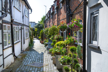 Windsor, UK - May 5, 2018: Little street in old Eton, decorated with flower pots