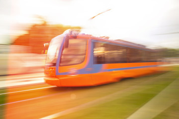Obraz premium High speed passenger train in motion on railroad. A tram with motion blur effect.