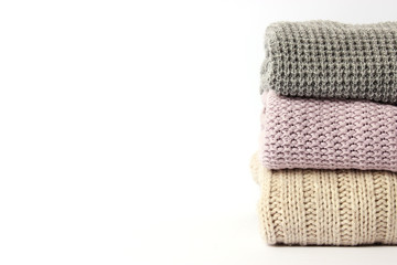 an ideal stack of warm clothes on a monophonic background. minimalism.