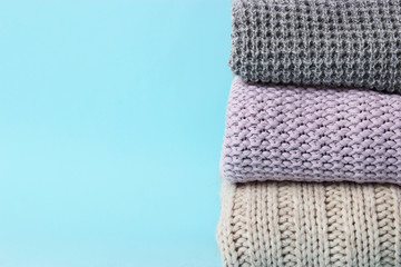 an ideal stack of warm clothes on a monophonic background. minimalism.