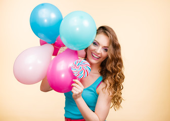 Woman with colorful balloons and lollipop