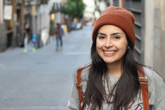 Cute Latin woman smiling on the street 