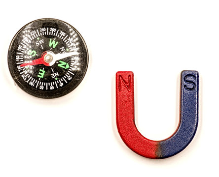 U-shaped red and blue magnet and black compass isolated on white background