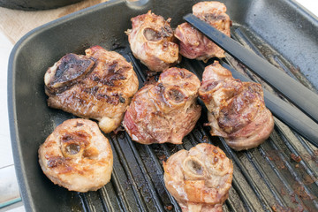 Fried turkey pieces in the grill pan close-up