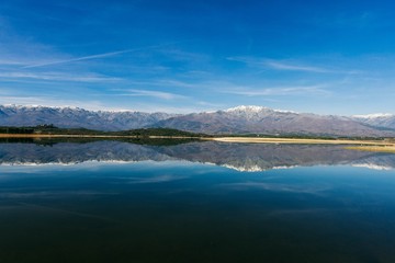 View over the lake with snowy mountains. Beautiful mountain landscape. Afternoon mountainous Spanish  scenery  