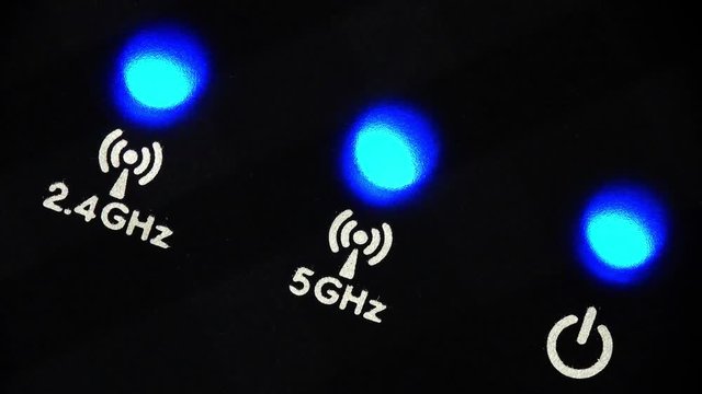 Blinking LEDs on a modern wireless router with 2.4 GHz and 5 GHz bands