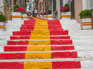 long staircase painted with the colors of the Spanish flag in a characteristic neighborhood of...