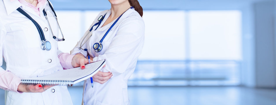 Impersonal portrait of a female doctor in front of a bright background
