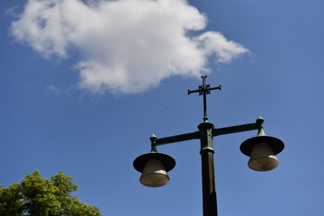 Fototapeta na wymiar Christian cross on a cemetery lantern in Berlin-Stahnsdorf