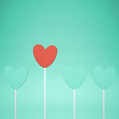 Minimal love and care concept idea, red and turquoise heart shape candies on pastel background with copy space