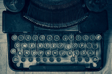 Dirty vintage typewriter keyboard in German