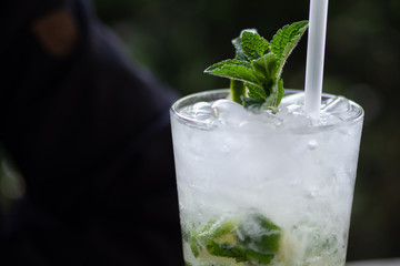Refreshing mojito cocktail with mint sprig and condensation