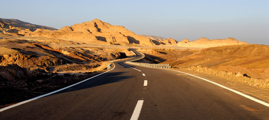 Highway in desert, yellow rock, Egypt