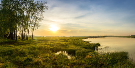 Fototapeta na wymiar летний вечерний пейзаж на Уральской реке с соснами на берегу, Россия, июнь