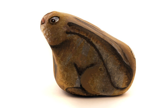 On the stone from the sea shore a hare with frightened eyes and pressed ears, on a white background, is drawn.