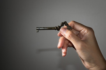 Old key in girl hand.